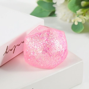 Pink diamond-shaped squishy stress relief toy with glitter inside for relaxation
