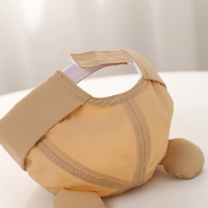 Detail view of khaki baby cap featuring adjustable velcro strap and premium cotton stitching