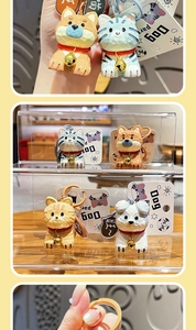 Detailed view of cute resin animal keychains with golden bells and red collars