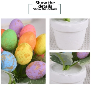 Detail showing colorful speckled Easter eggs and green foliage in a white planter