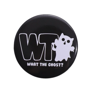 Round tinplate badge with cartoon ghost and What The Ghost slogan on black background
