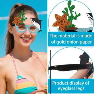 Detail of ocean-themed glitter paper party glasses showing shark and starfish designs