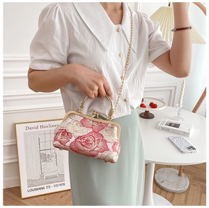Detail of pink rose floral embroidered cheongsam handbag with gold chain and handle