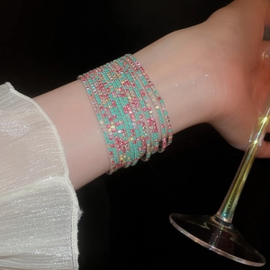 Elegant multi-layer rhinestone stretch bracelet in mint green and rose pink on wrist