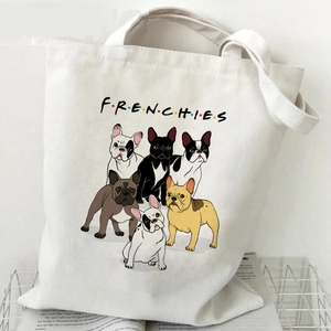 Beige canvas French Bulldog tote bag with colorful dog illustrations and text in a wire basket