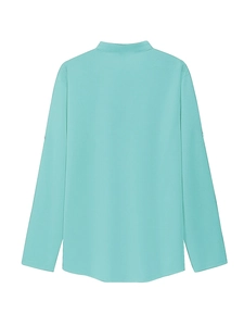 Detail of light blue long sleeve polo shirt with textured fabric and sleeve button tab