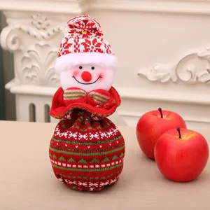 Knitted snowman Christmas gift bag with drawstring closure and festive apple decorations