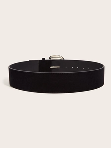 Macro shot of black suede wide waist belt with metallic silver buckle and pin details