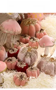 Detail of velvet pumpkin and mushroom ornaments with glitter accents for Christmas