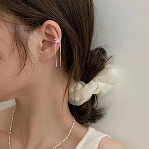 Elegant silver bow tassel ear cuff with long zircon fringe on model profile view