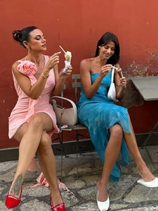 Detail of pink one-shoulder rose dress and blue strapless maxi dress for summer vacations