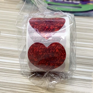 Roll of red heart-shaped glitter stickers for Valentine's gift sealing and decoration