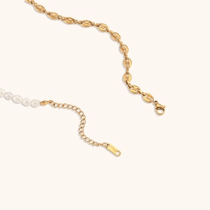 Detail of gold bean chain necklace with white pearls and K18 engraving on the clasp tag
