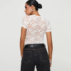 Rear view of white lace bodysuit with floral pattern and delicate lace trim sleeves