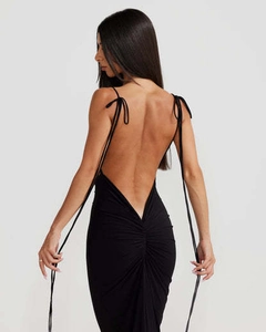 Detail of the backless ruched design and crisscross straps on the black bodycon maxi dress