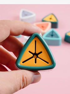 Close-up of a dark green towel plug with an orange star-shaped silicone insert for grip