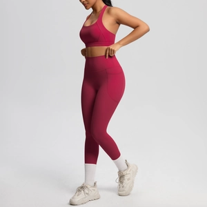 Detail view of burgundy yoga set featuring side phone pocket on high-waist leggings