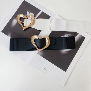 Detail showing elastic belts with gold heart buckles in black and white colors