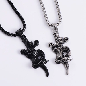 Detail of punk style snake and sword pendant necklaces in black and antique silver finishes
