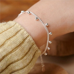 Macro shot of S925 sterling silver beaded bracelet with polished round ball charms