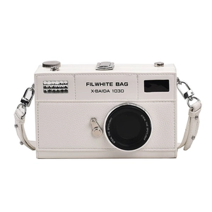 Detailed macro shot of vintage camera shaped shoulder bag in white lychee pattern