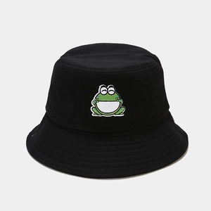 Close-up of a smiling cartoon frog embroidery on a black cotton bucket hat