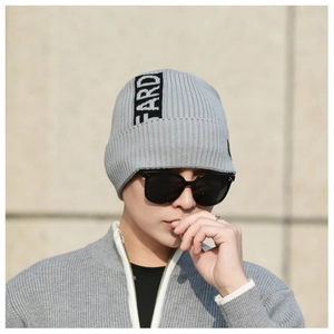 Close-up of grey ribbed knit beanie showing FARD lettered ribbon detail and texture