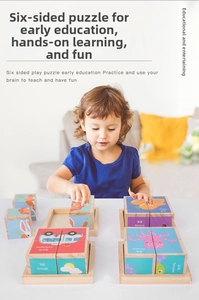 Close-up of a child playing with educational six-sided wooden 3D building blocks