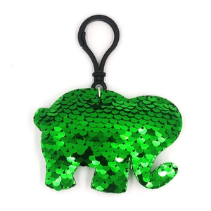 Close-up of a green sequined elephant keychain with a black hook on a white background