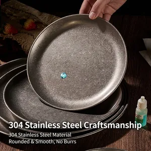 Industrial vintage 304 stainless steel round plate with brushed matte finish on wood table