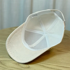 Detail view of the cotton baseball cap interior with quality wash label showing 100% cotton
