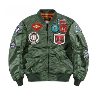 Detailed view of military green flight jacket with vintage tactical embroidery patches