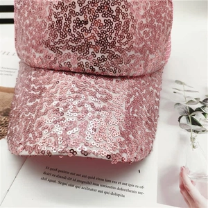 Detailed close-up of pink sequined baseball cap showing reflective texture and finish