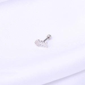 Detailed macro view of a silver fishbone ear stud with sparkling cubic zirconia inlay