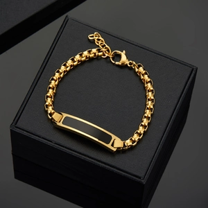 Polished 18K gold plated stainless steel Cuban chain bracelet on a black gift box