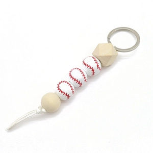 Baseball themed keychain with white wooden beads, red stitching, and white leather tassel