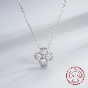 Detailed macro view of S925 sterling silver four-leaf clover pendant with white zircons