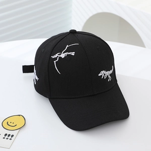 Close-up of white dinosaur skeleton embroidery on a black kids baseball cap with curved brim