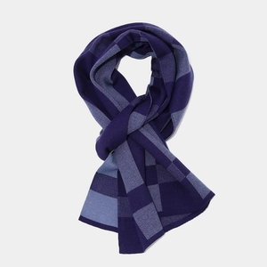 Detail of knit scarf with dark and grey-blue checkered pattern for winter warmth