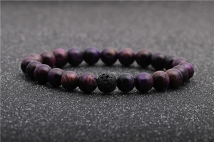 Detailed view of purple tiger eye stone beads and black lava stone on a beaded bracelet