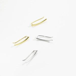Detail of minimalist S925 sterling silver curved hook earrings in gold and silver finishes