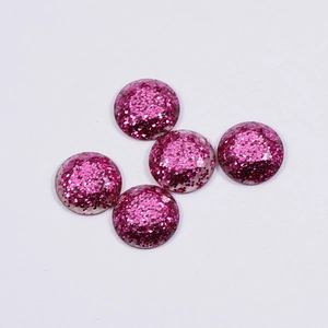 Five round pink glitter resin cabochons for DIY jewelry making on white background