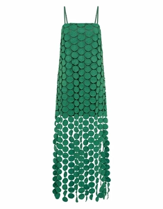 Detailed macro view of emerald green tiered circular patches and hollowed tassels