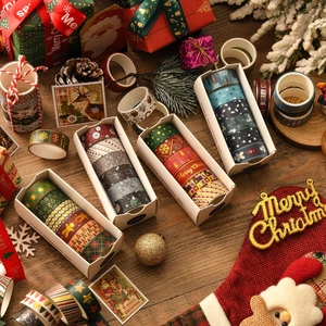 Christmas washi tape set with gold foil festive patterns on a rustic wooden background