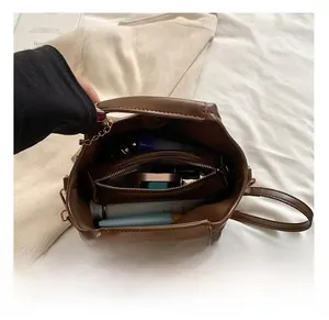 Interior detail of brown wax leather tote bag showing spacious storage with a zipper pocket