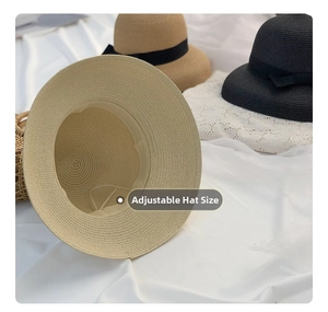 Detail showing adjustable interior band feature of woven straw hats with black ribbons