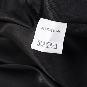 Close-up of internal wash care label showing 100% polyester fabric on a black coat