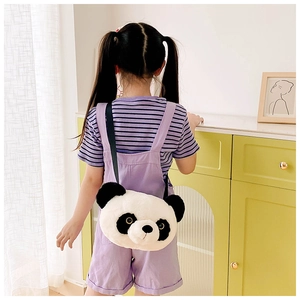 Detail showing plush panda shoulder bag worn by a young girl in a cozy home setting