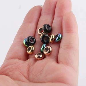 Macro shot of colorful 8mm stainless steel stopper beads with rubber lining held in palm