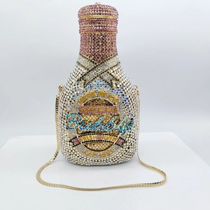 Detail of crystal champagne bottle clutch bag with pink and gold rhinestones